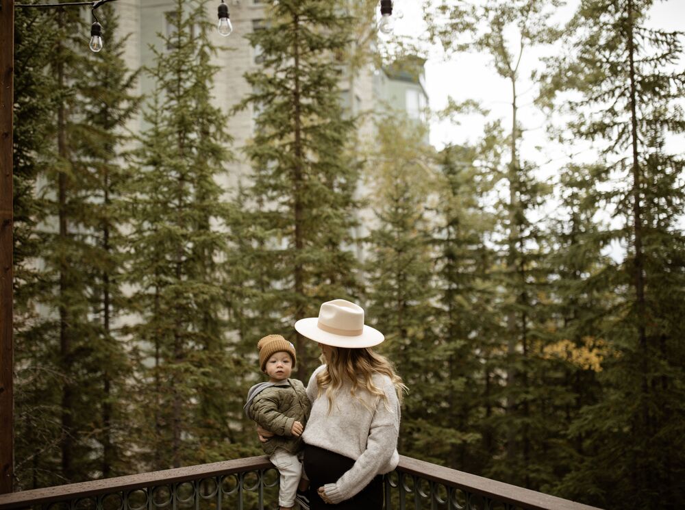 Lifestyle images of a woman and her family exploring the Rimrock Resort Hotel in Banff National Park.