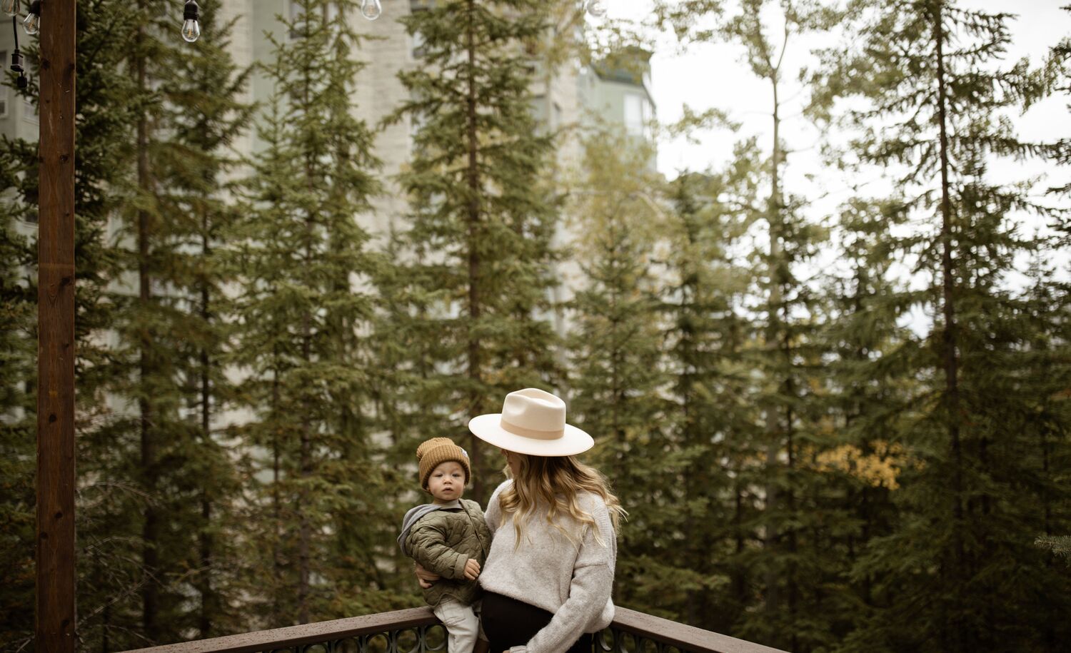 Lifestyle images of a woman and her family exploring the Rimrock Resort Hotel in Banff National Park.