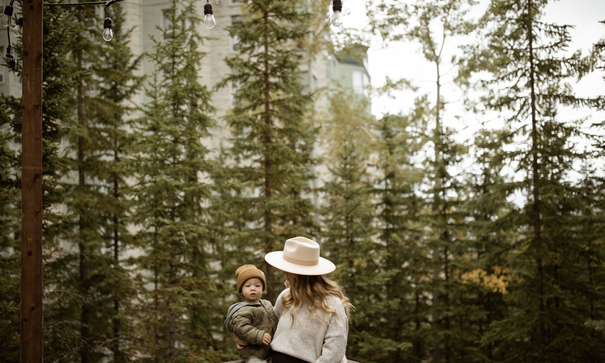 Lifestyle images of a woman and her family exploring the Rimrock Resort Hotel in Banff National Park.