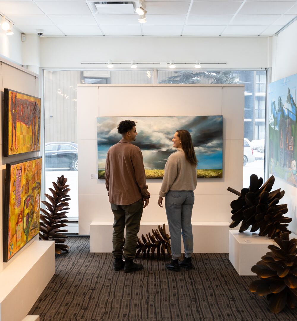 Two people viewing art at the Canada House Gallery