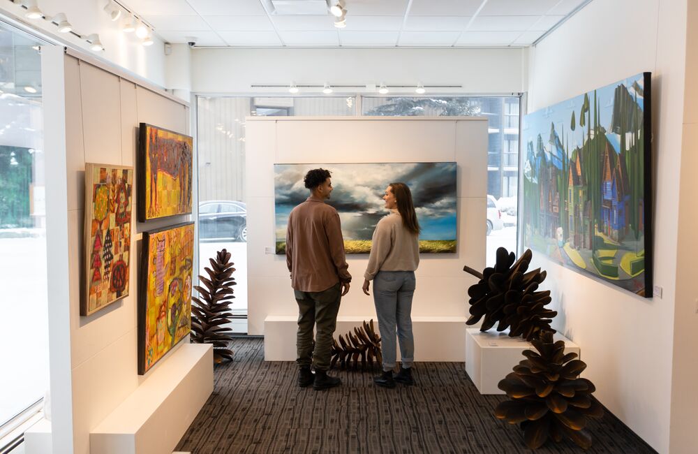Two people viewing art at the Canada House Gallery