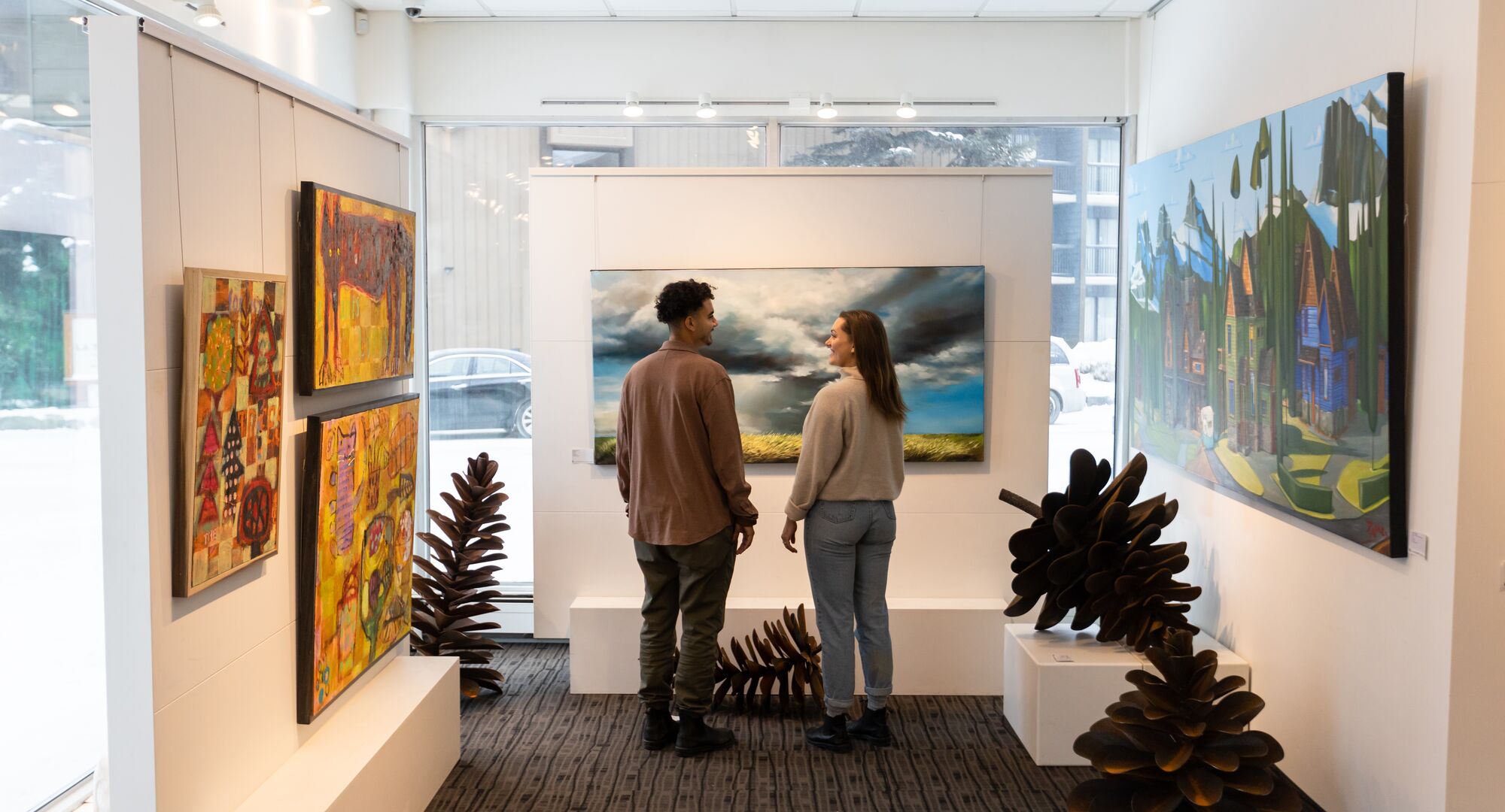 Two people viewing art at the Canada House Gallery