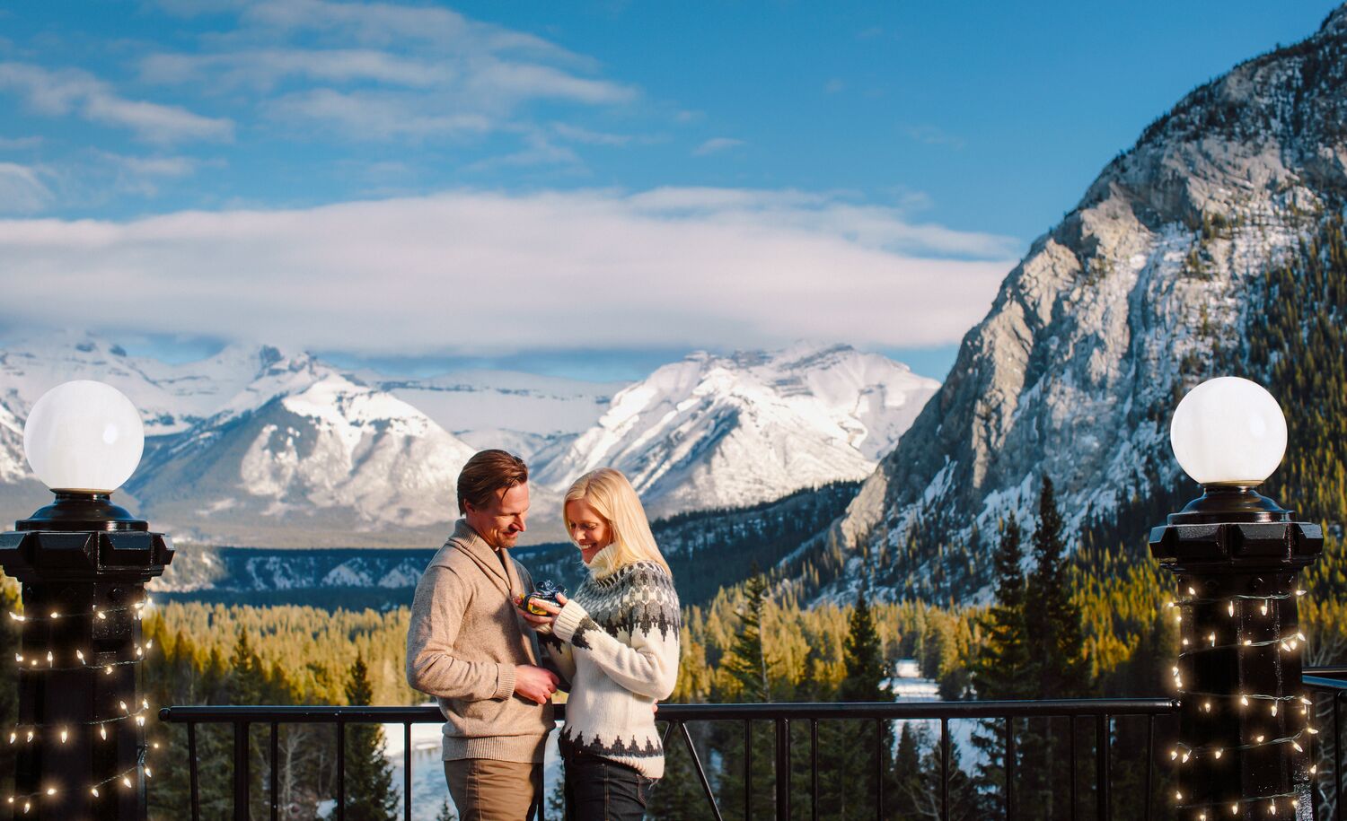 Two people getting engaged at Rundle Bar at the Fairmont Banff Springs.