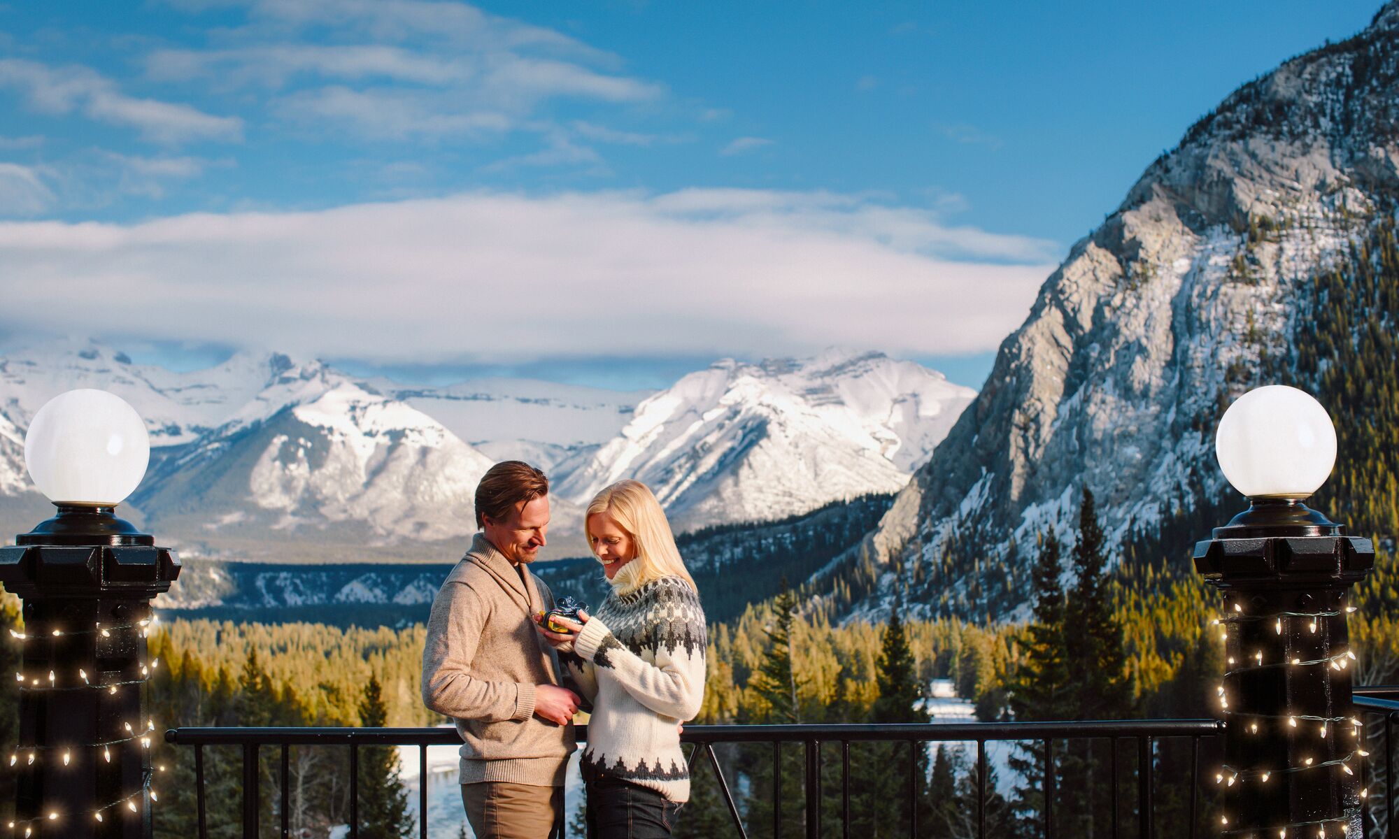 Two people getting engaged at Rundle Bar at the Fairmont Banff Springs.
