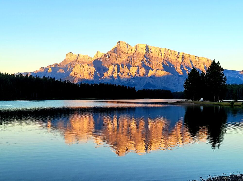 Sunrise at Two Jack Lake with Mount Rundle lit up in Banff National Park.