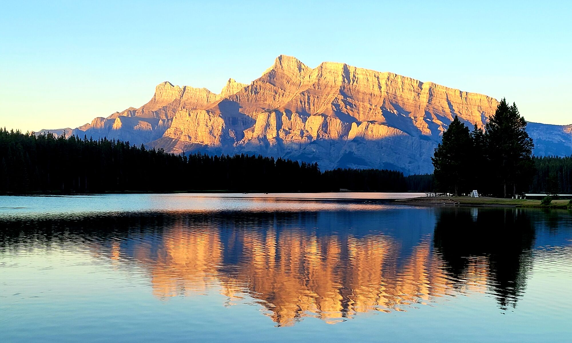 Sunrise at Two Jack Lake with Mount Rundle lit up in Banff National Park.