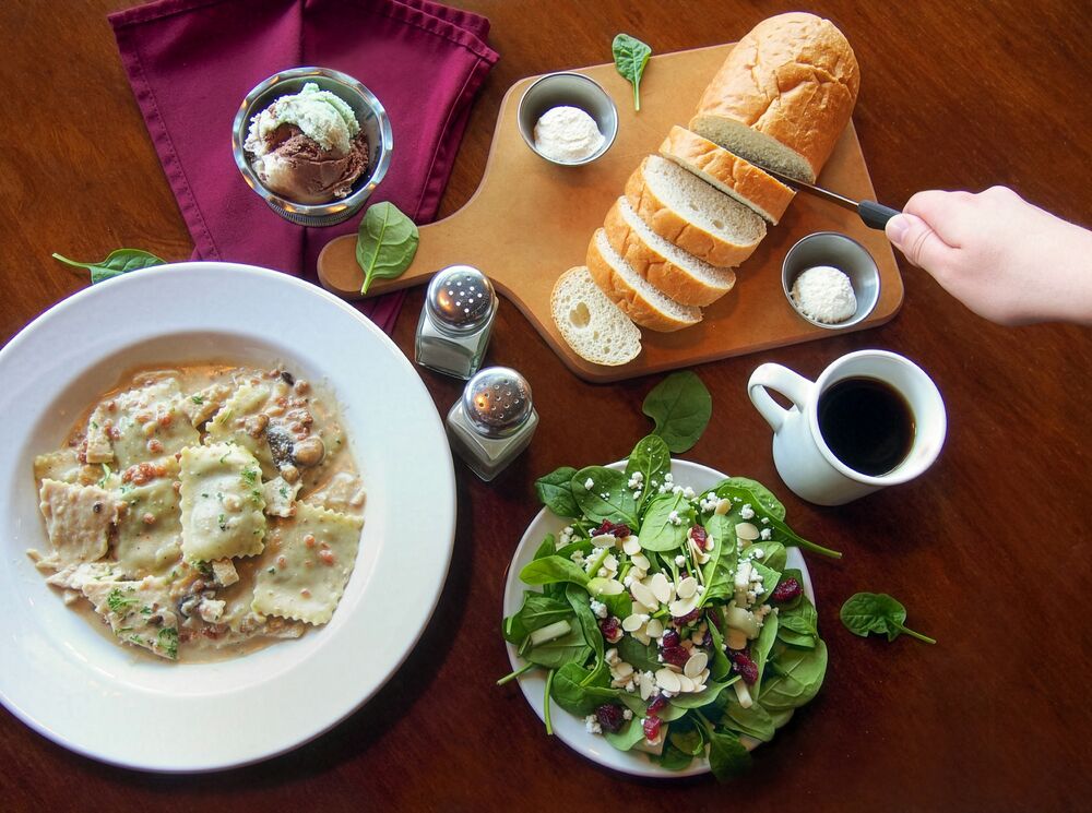 Pasta, salad and bread on a table as seen from above at The Old Spaghetti Factory in Banff.