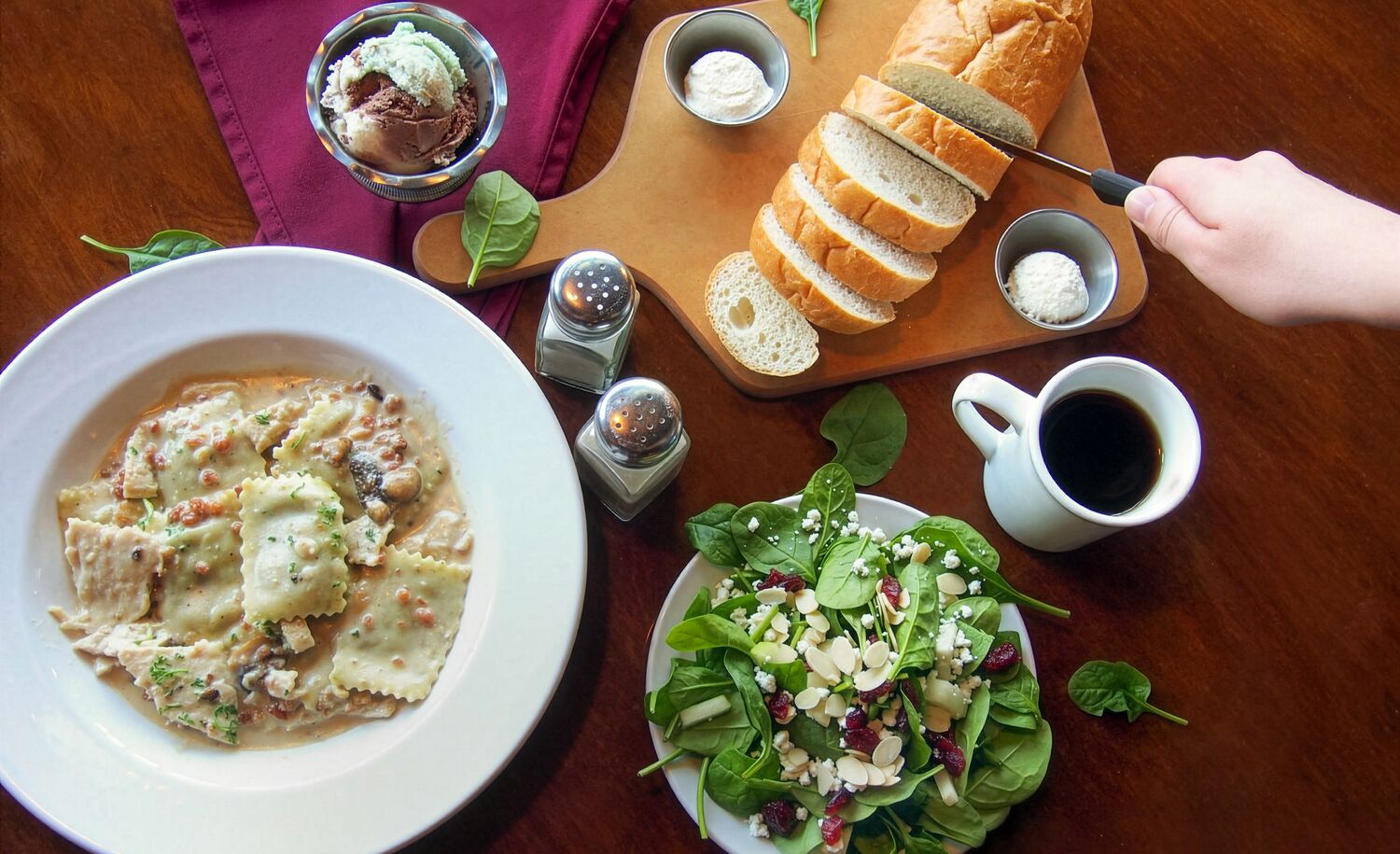 Pasta, salad and bread on a table as seen from above at The Old Spaghetti Factory in Banff.