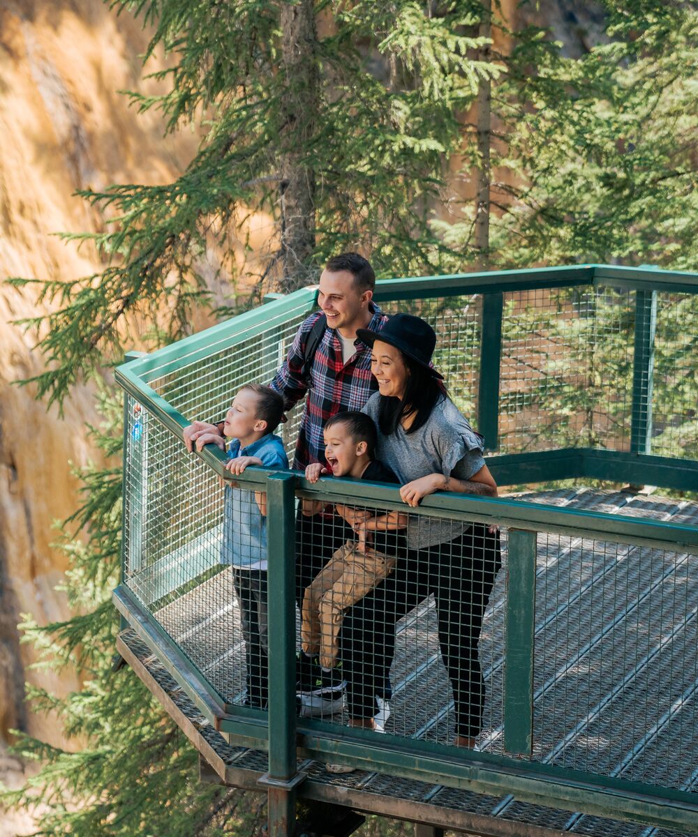 A family hiking at Johnston Canyon in the summer in Banff National Park.