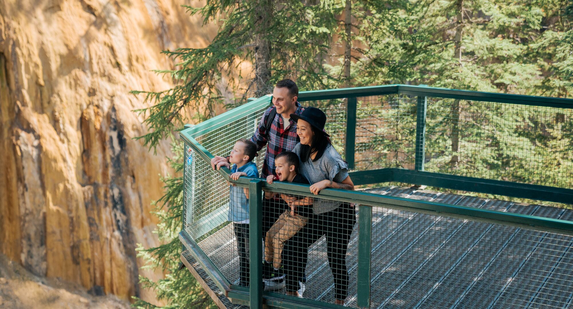 A family hiking at Johnston Canyon in the summer in Banff National Park.