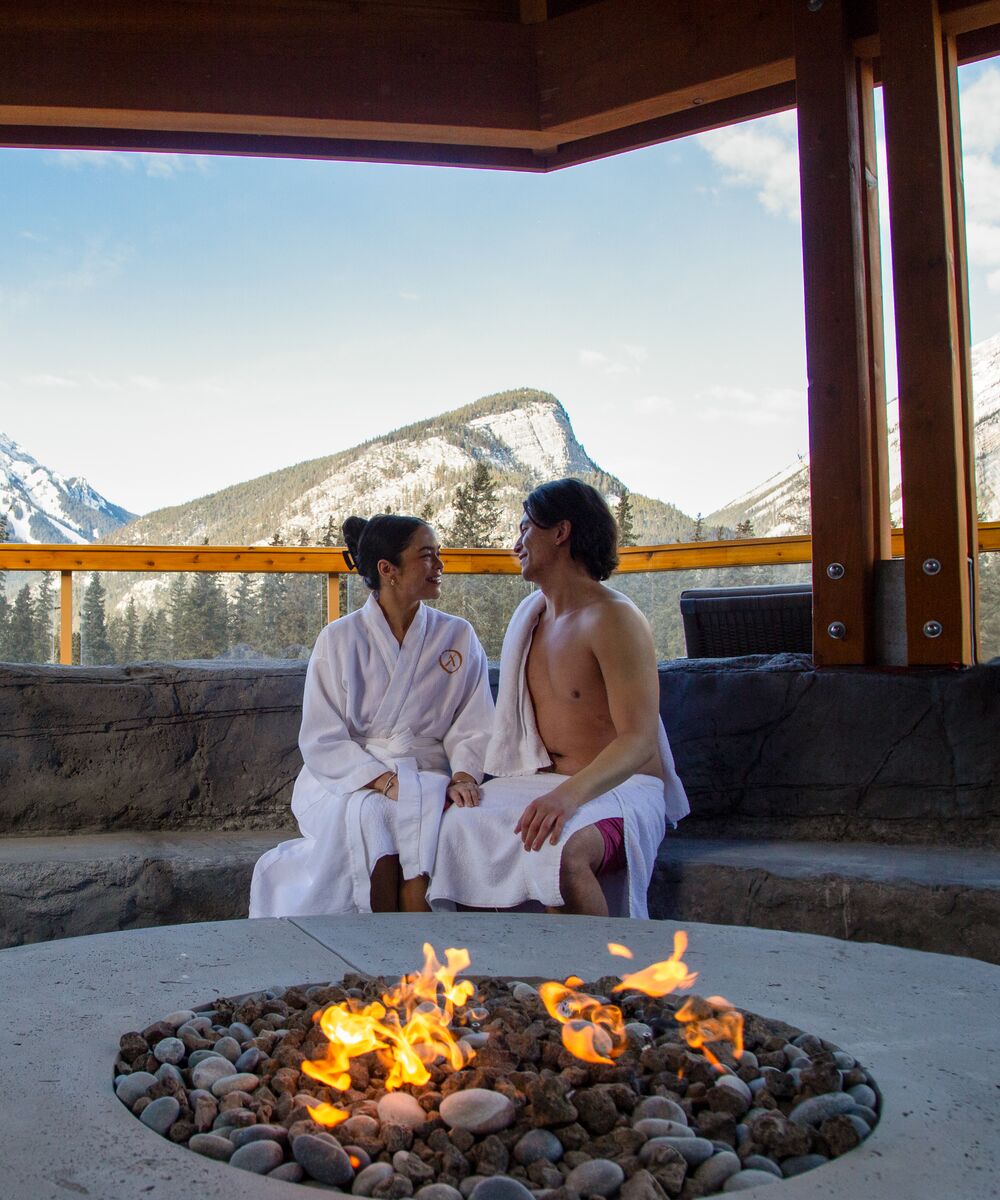 Two people at a spa outdoors at the Canoe Hotel in Banff