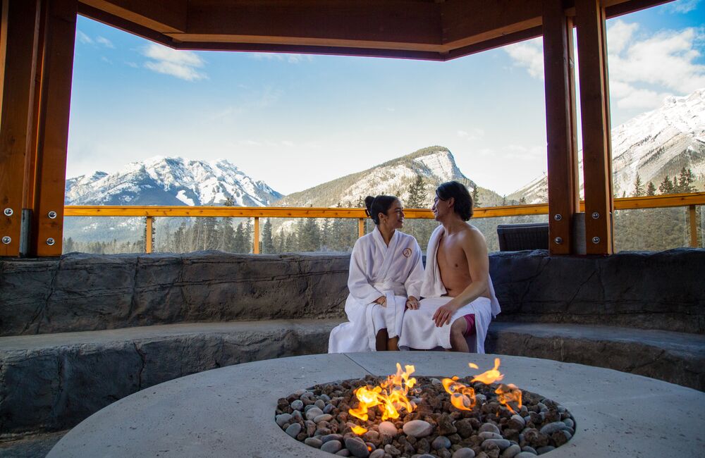 Two people at a spa outdoors at the Canoe Hotel in Banff