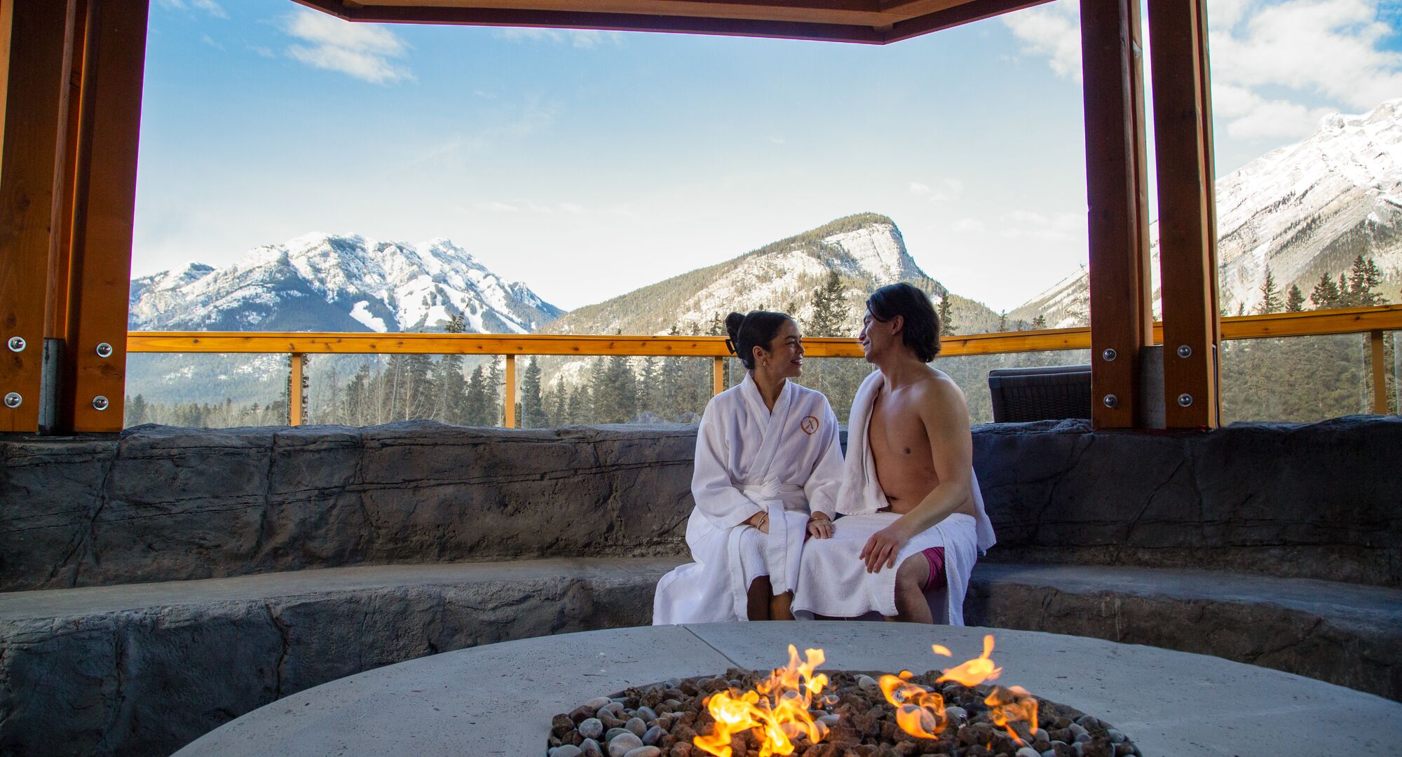 Two people at a spa outdoors at the Canoe Hotel in Banff