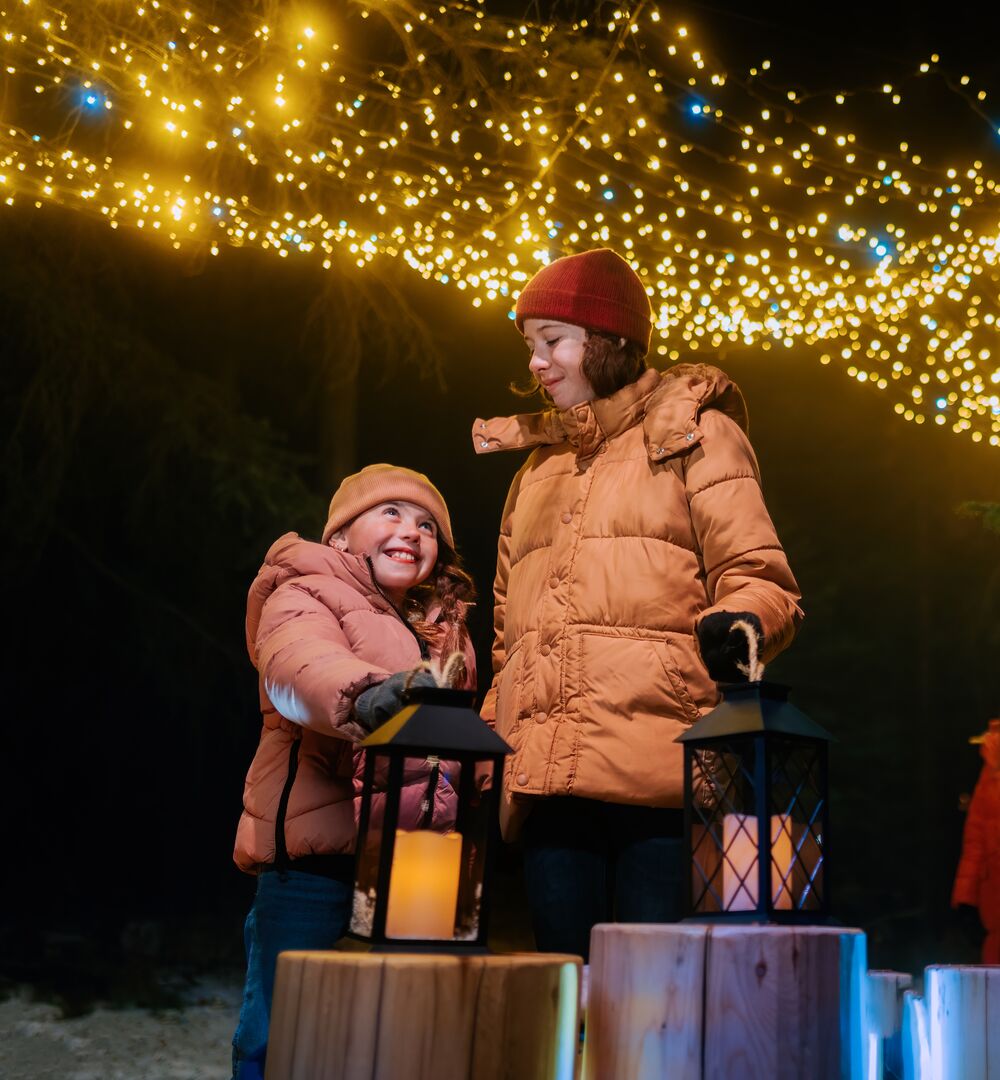 A family amongst Christmas light at In Search of Christmas in Banff National Park