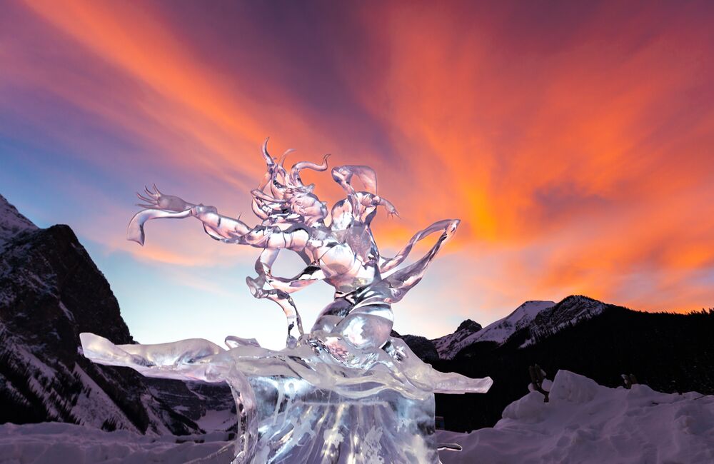 An ice sculpture on display at Lake Louise with the Fairmont Chateau Lake Louise in the background.