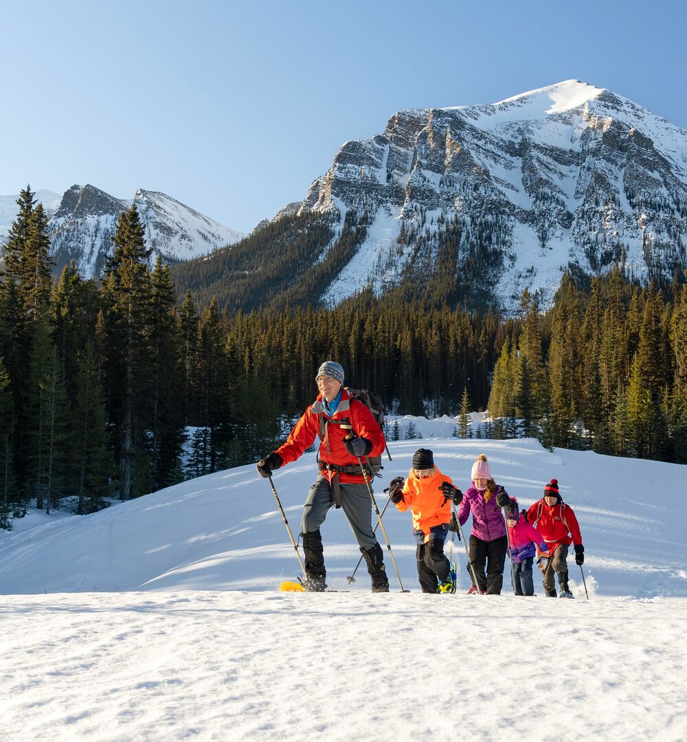 Group of people snowshoeing in the winter in Banff National Park