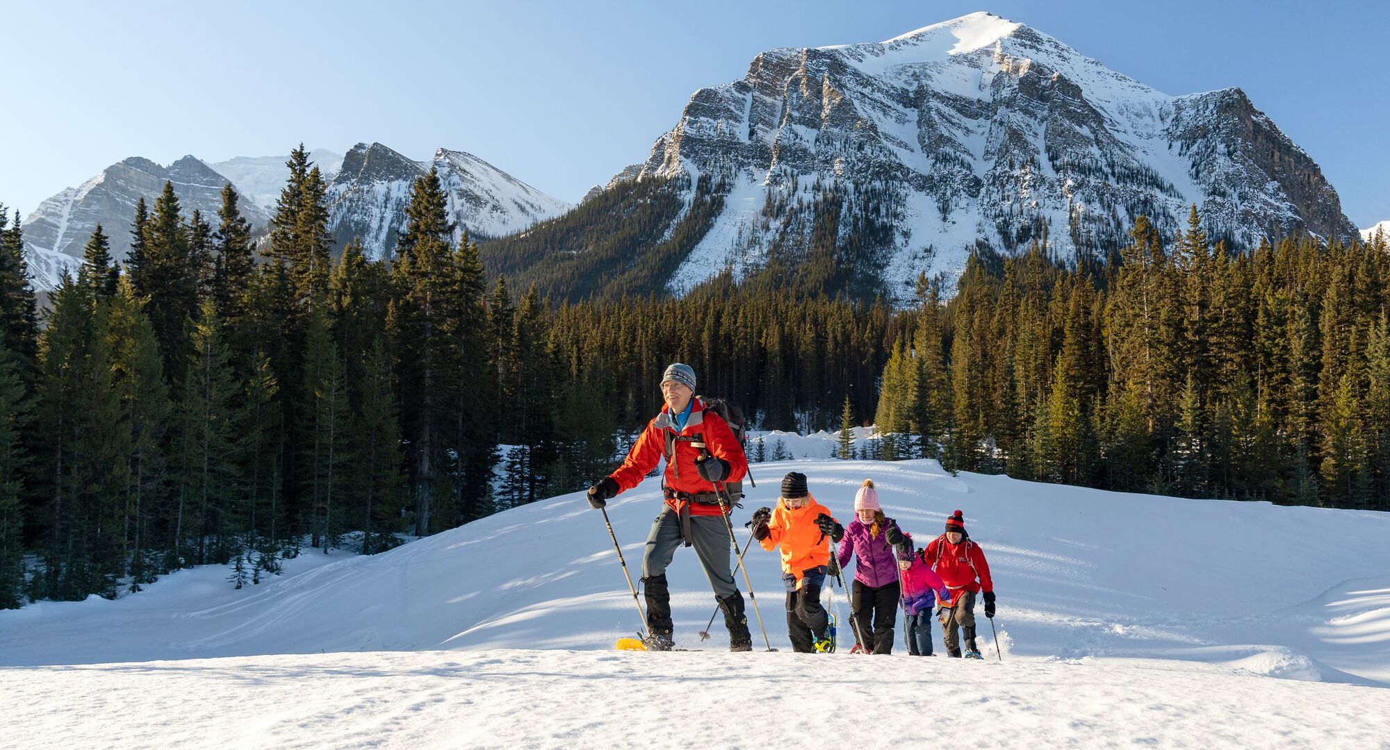 Group of people on a snowshoeing tour in the Lake Louise area on a bluebird winters day