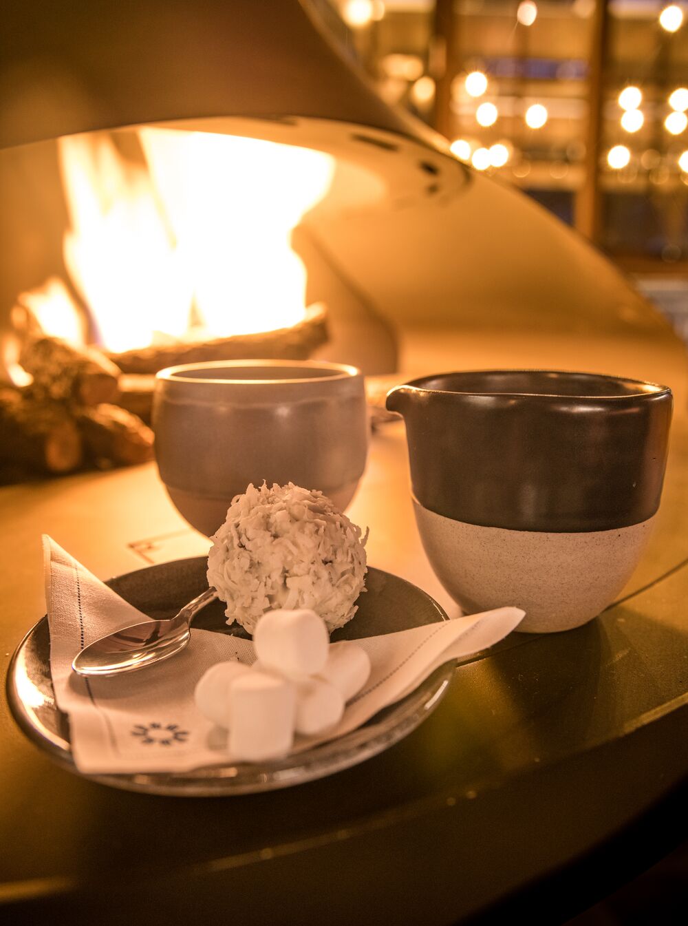 Two hot chocolates sit on a fireplace at Bluebird in Banff National Park.
