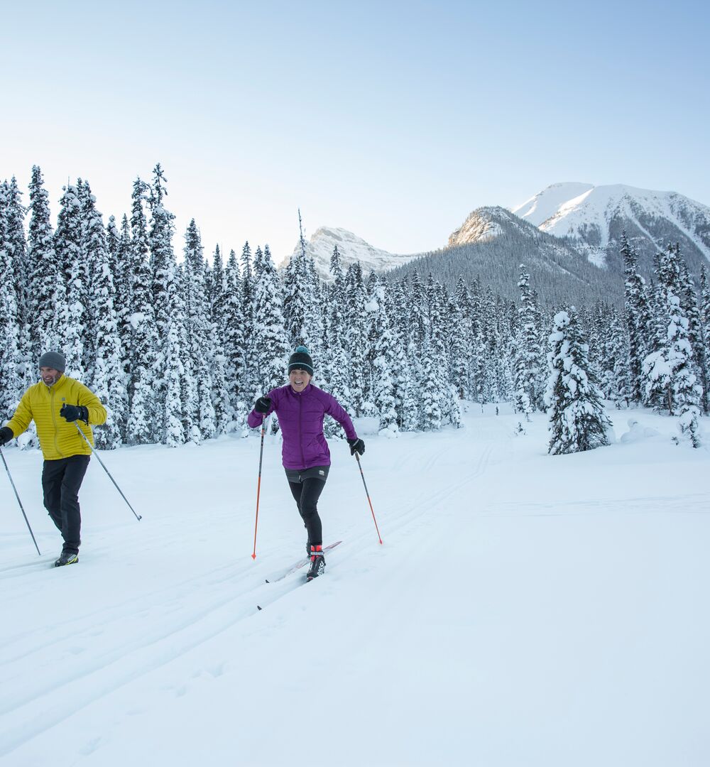Two people having fun on cross country skis on the Great Divide Trail at Lake Louise