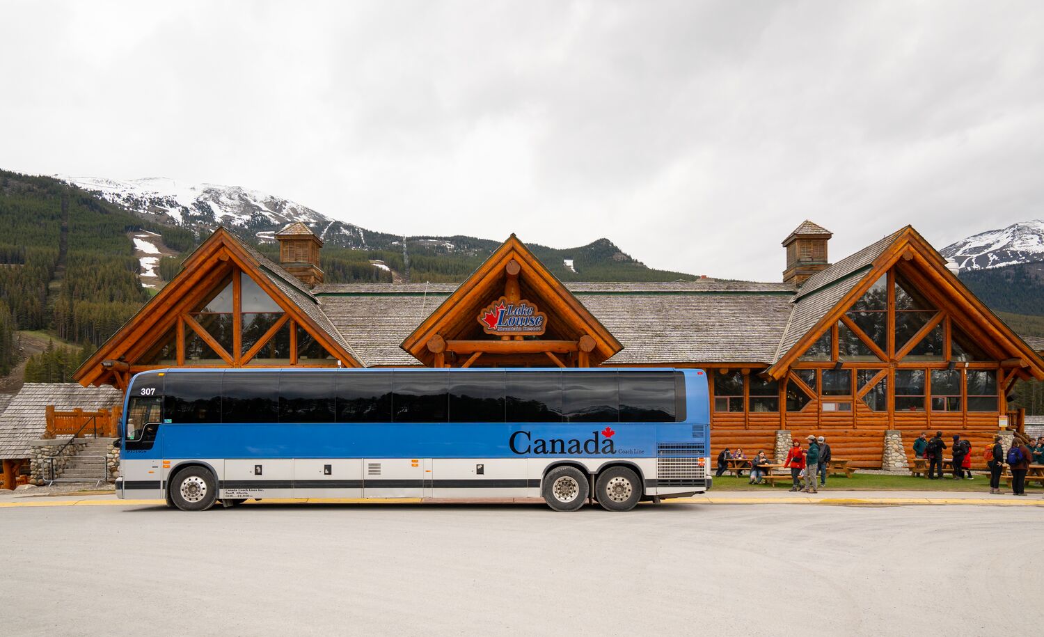 Parks Canada shuttle bus parked in front of the Lake Louise Ski Resort ready to take people to Lake Louise.