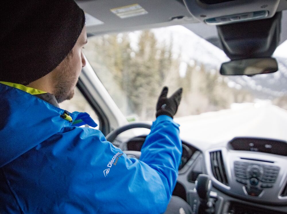 A Discover Banff Tours tour guide drives his tour group through Banff National Park