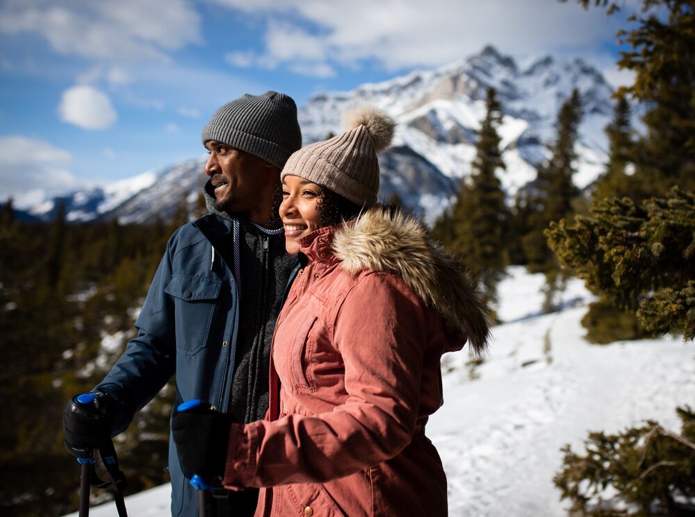 A couple hiking to a viewpoint in Banff National Park in spring