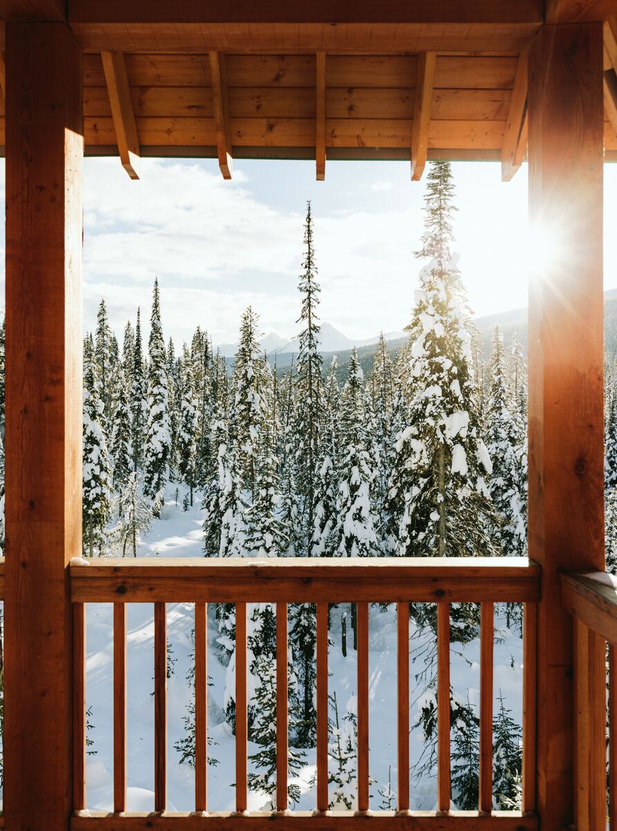 A view off a balcony at Emerald Lake Lodge toward a winter forest in Yoho National Park.