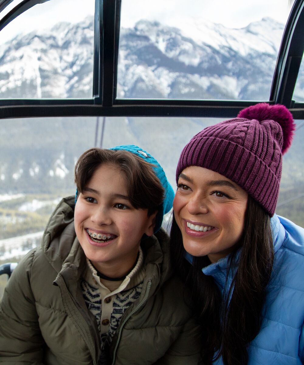 A mother and child enjoying the a ride on the Banff Gondola on the way to the top of Sulphur Mouintain
