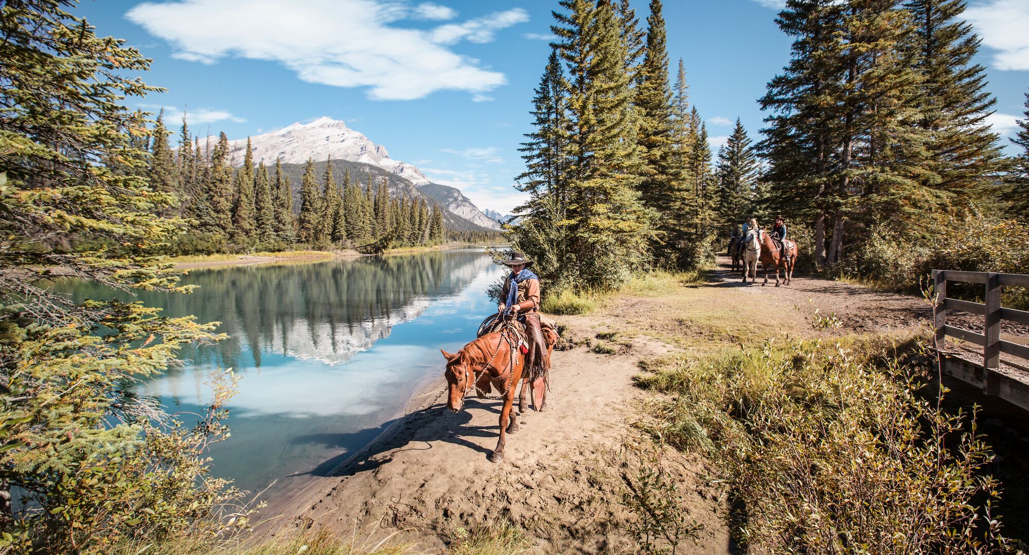 People on horses exploring the Marsh Loop on a horseback riding tour in Banff National Park