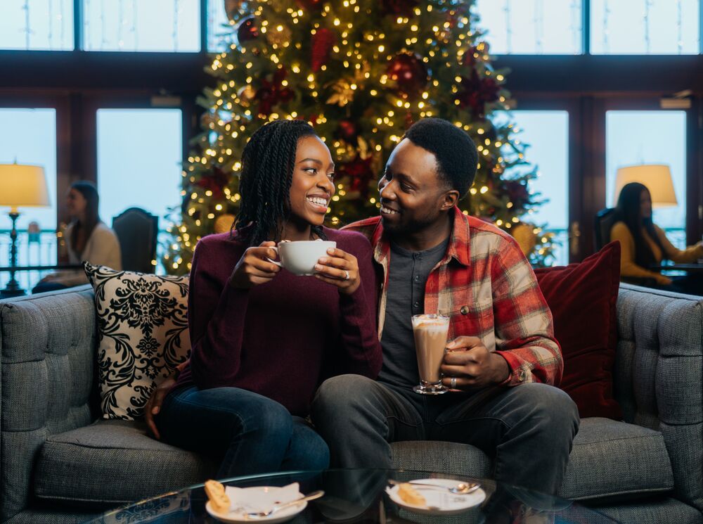 A couple on a couch in Banff at Christmas.