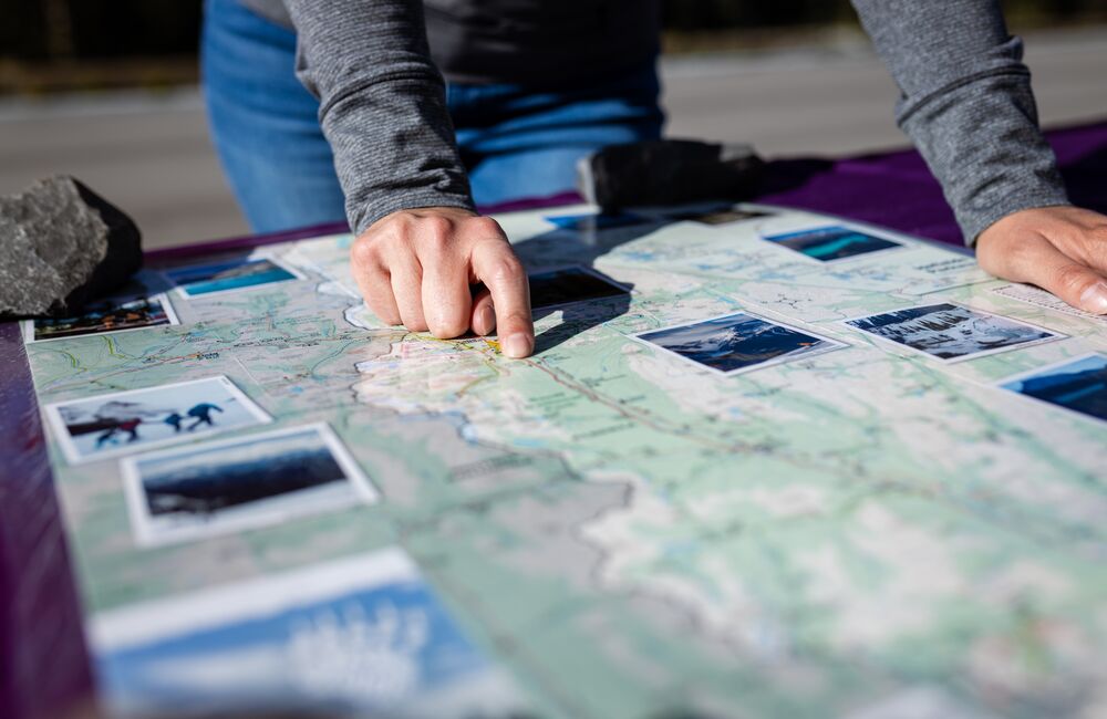 A Visitor Services team member with Banff Lake Louise Tourism is prepared to assist visitors at the Train Station Parking Lot