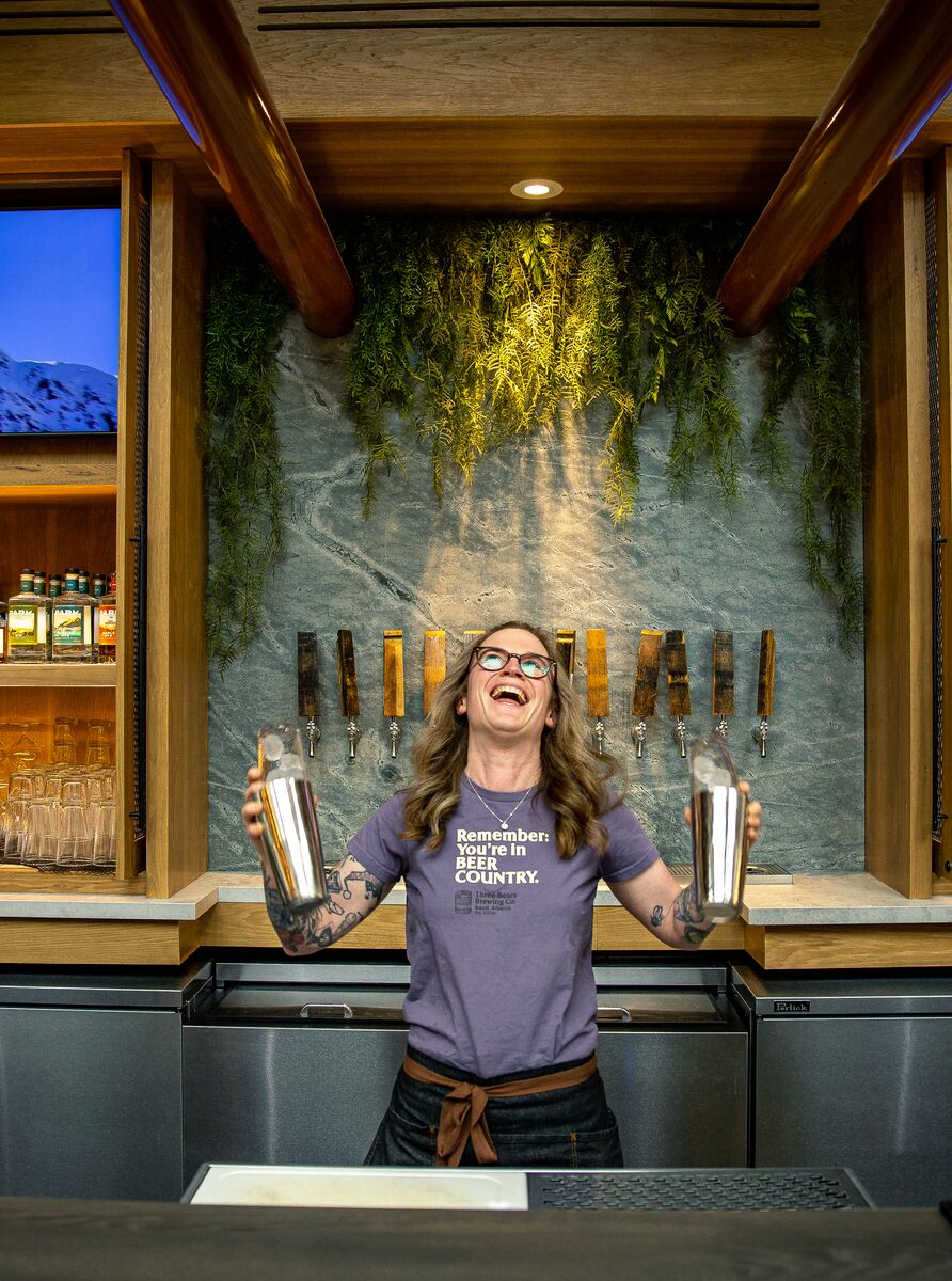 A woman makes two drinks at Three Bears Restaurant in Banff National Park.