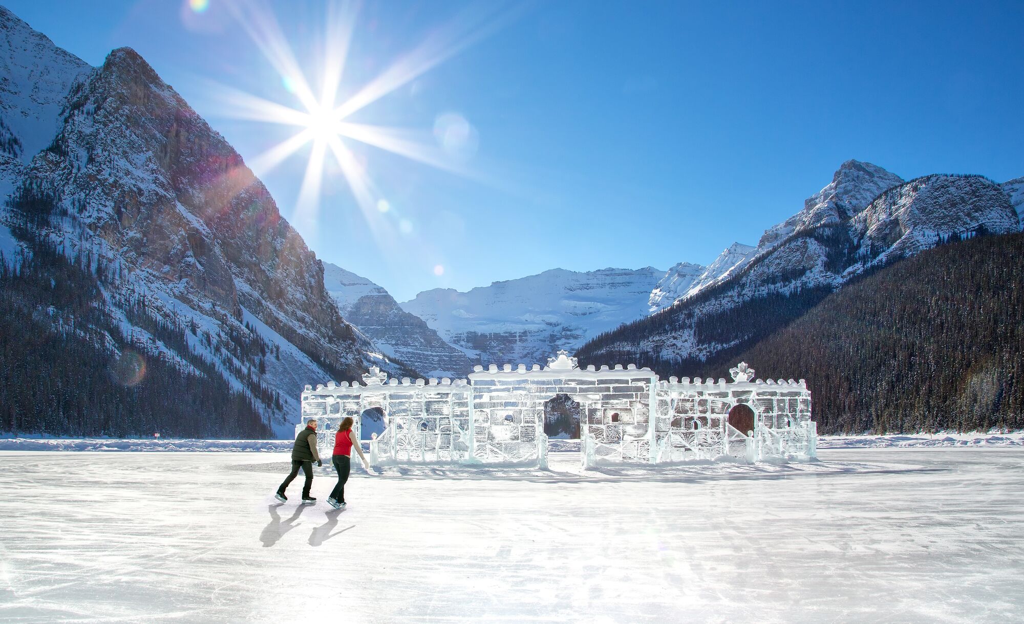 A couple skates by the ice castle on Lake Louise in Banff National Park.