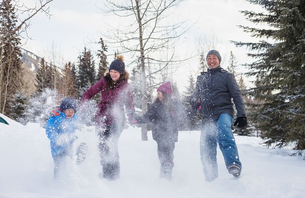 A family enjoying the snow in Central Park during the SnowDays Festival