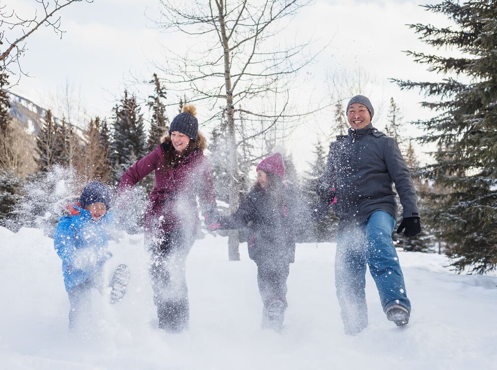 A family enjoying the snow in Central Park during the SnowDays Festival