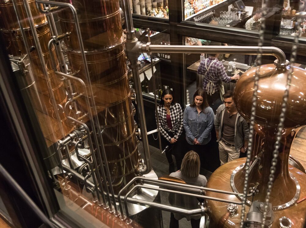Three people attend the gin tour at PARK Distillery in Banff National Park.