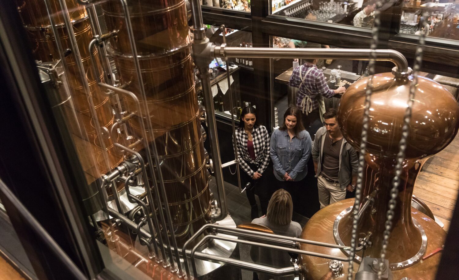 Three people attend the gin tour at PARK Distillery in Banff National Park.