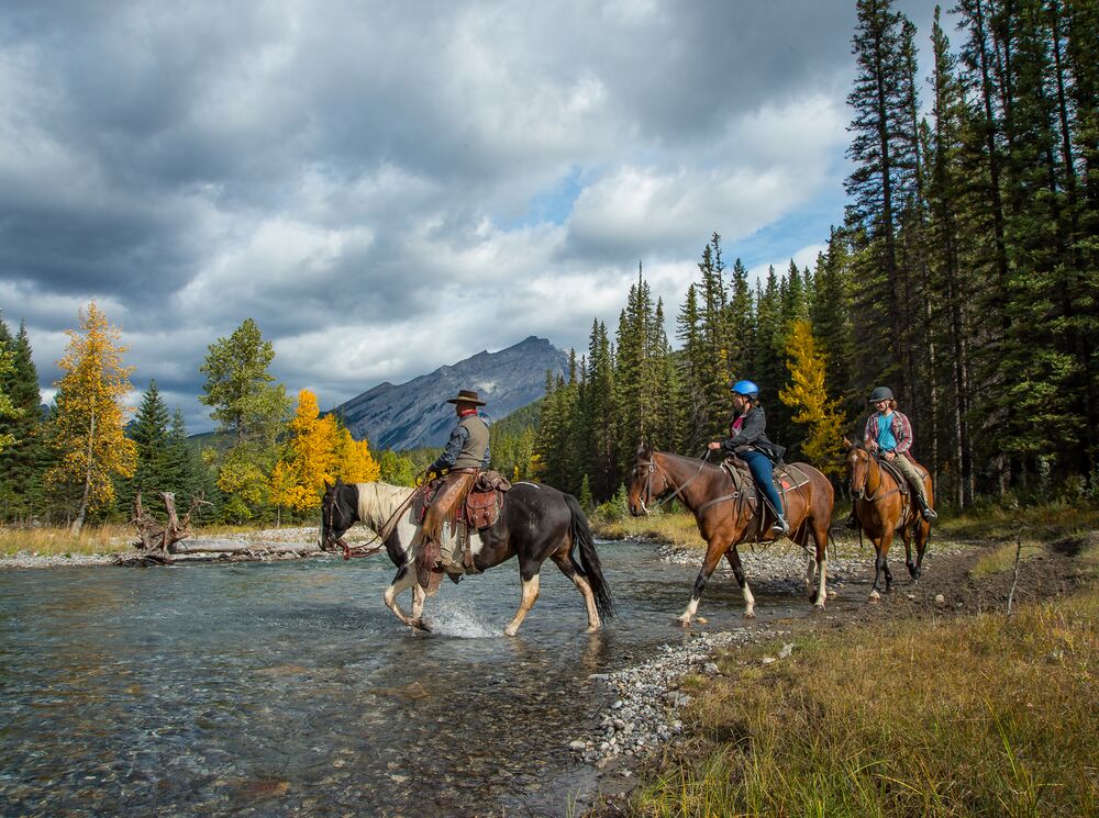 Three people horseback riding, one of the most popular things to do in Banff National Park in June