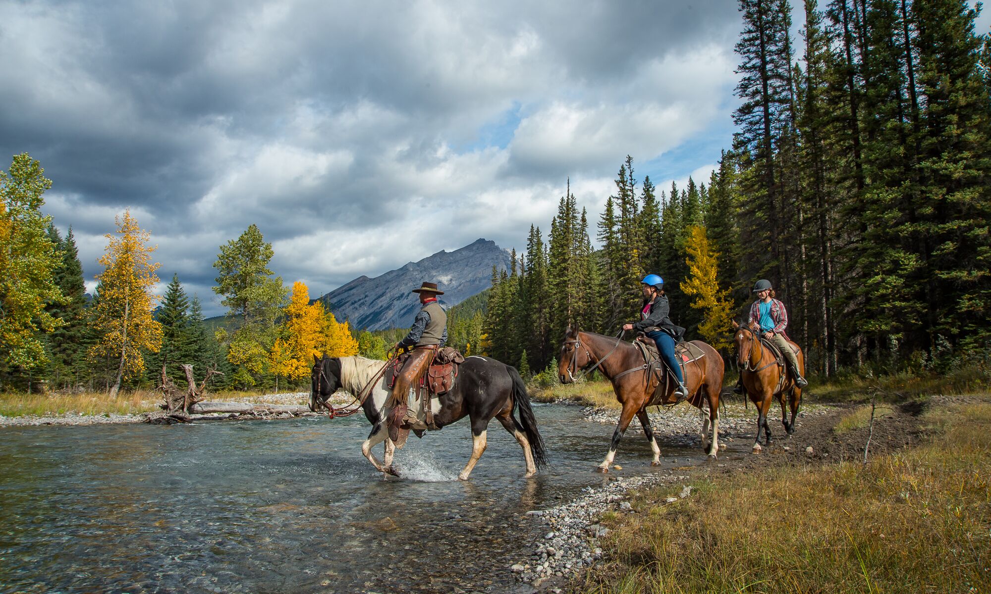 Three people horseback riding, one of the most popular things to do in Banff National Park in June