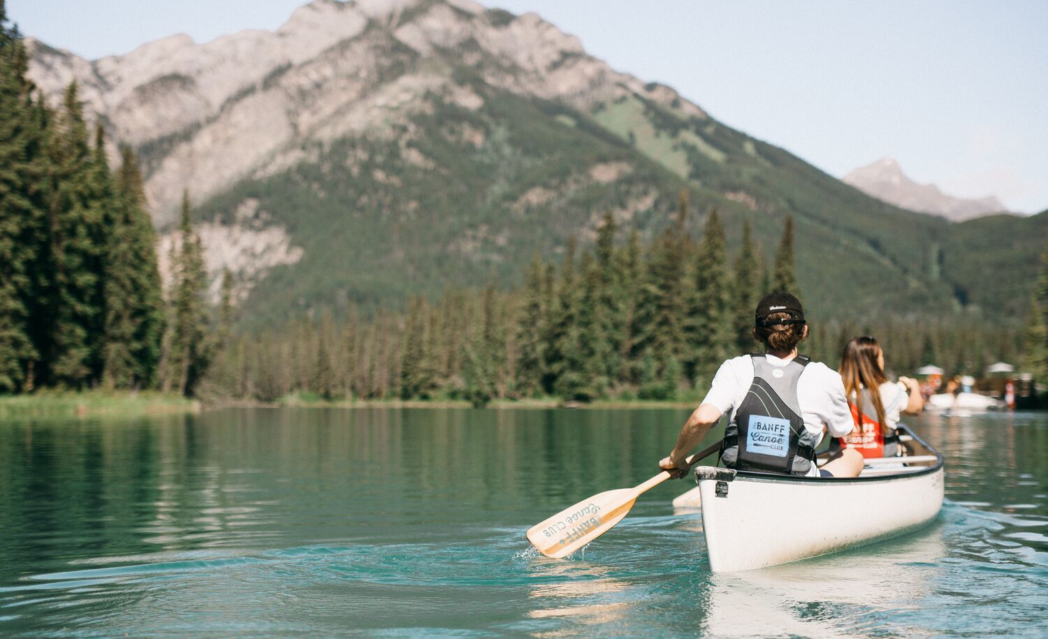 Two people canoeing on the Bow River in Banff National Park