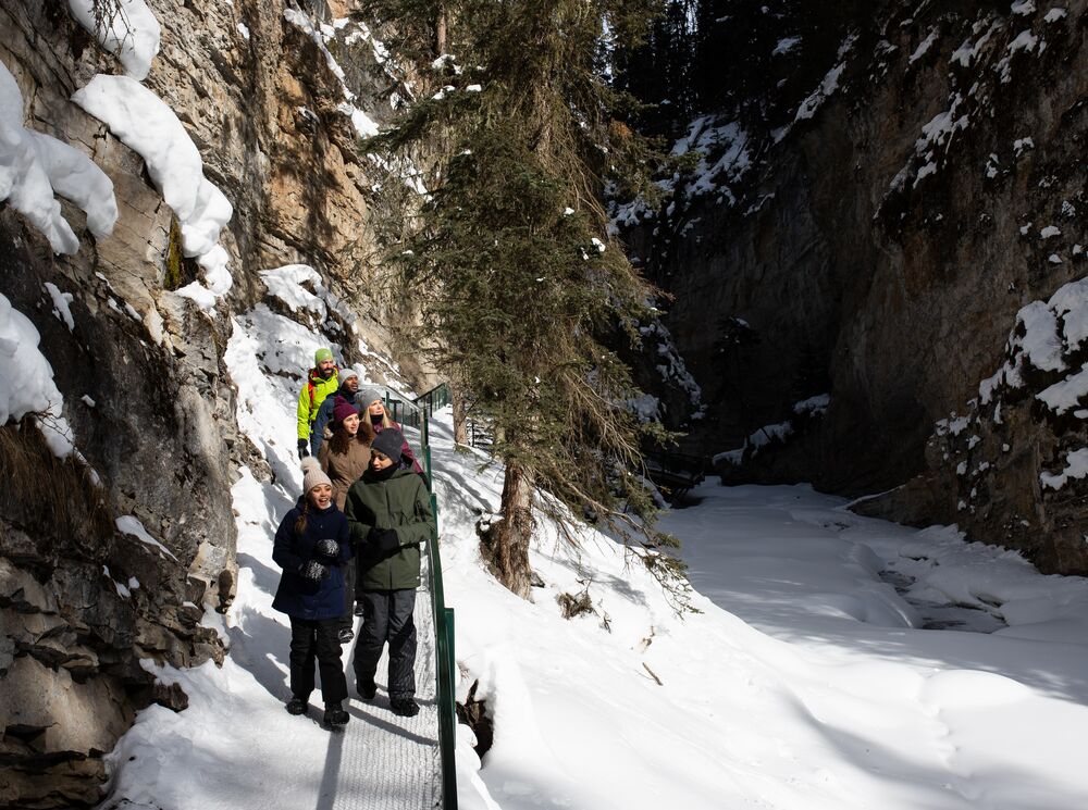 Group of people on a guided icewalk tour in Johnston Canyon