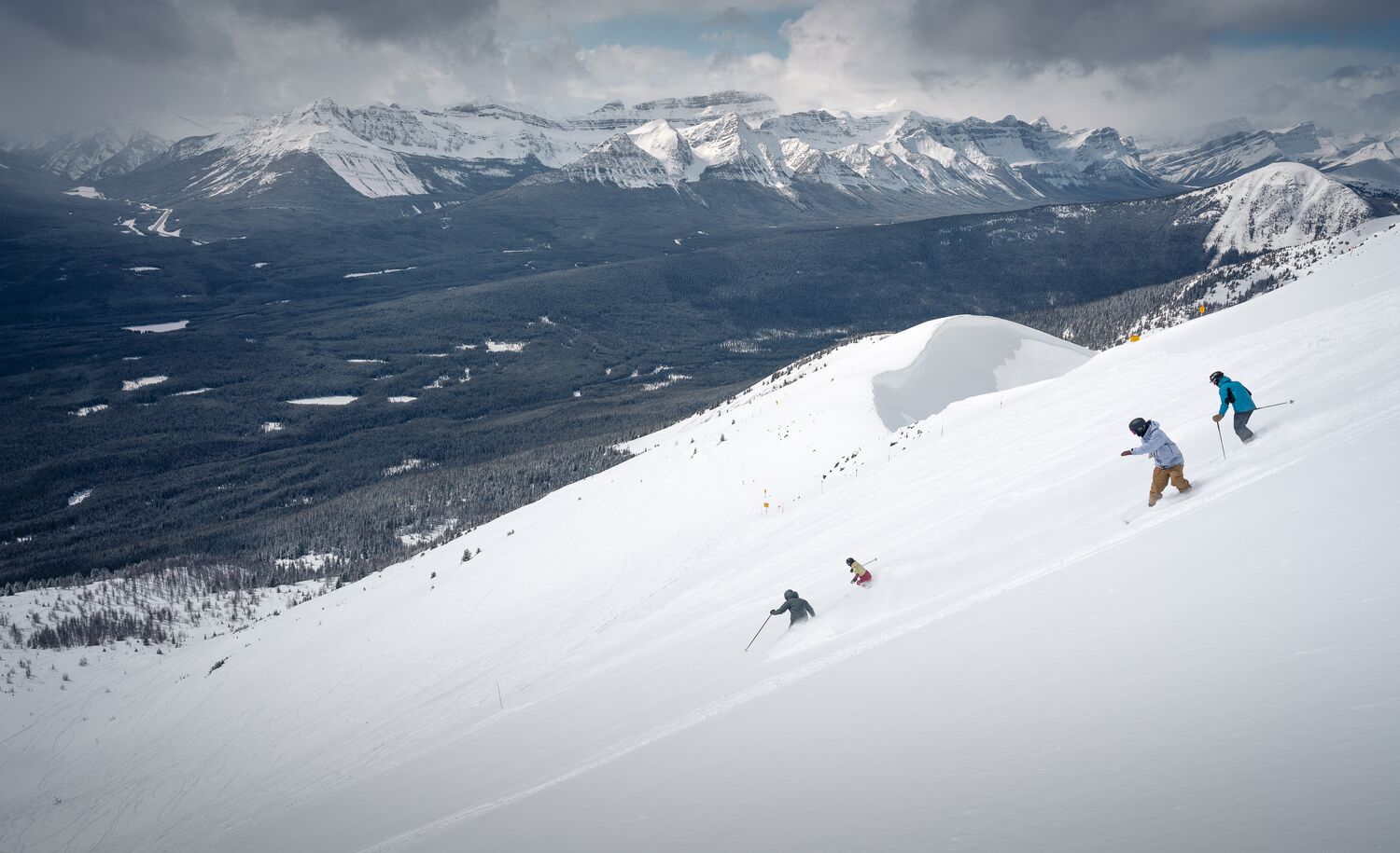 Skiers and snowboarders head down the West Bowl at Lake Louise Ski Resort in Banff National Park