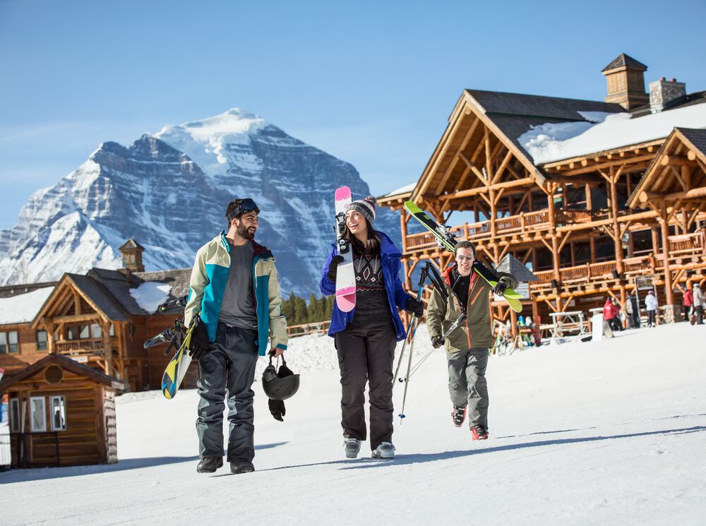 Two people walk at Lake Louise Ski Resort during the spring in Banff National Park.