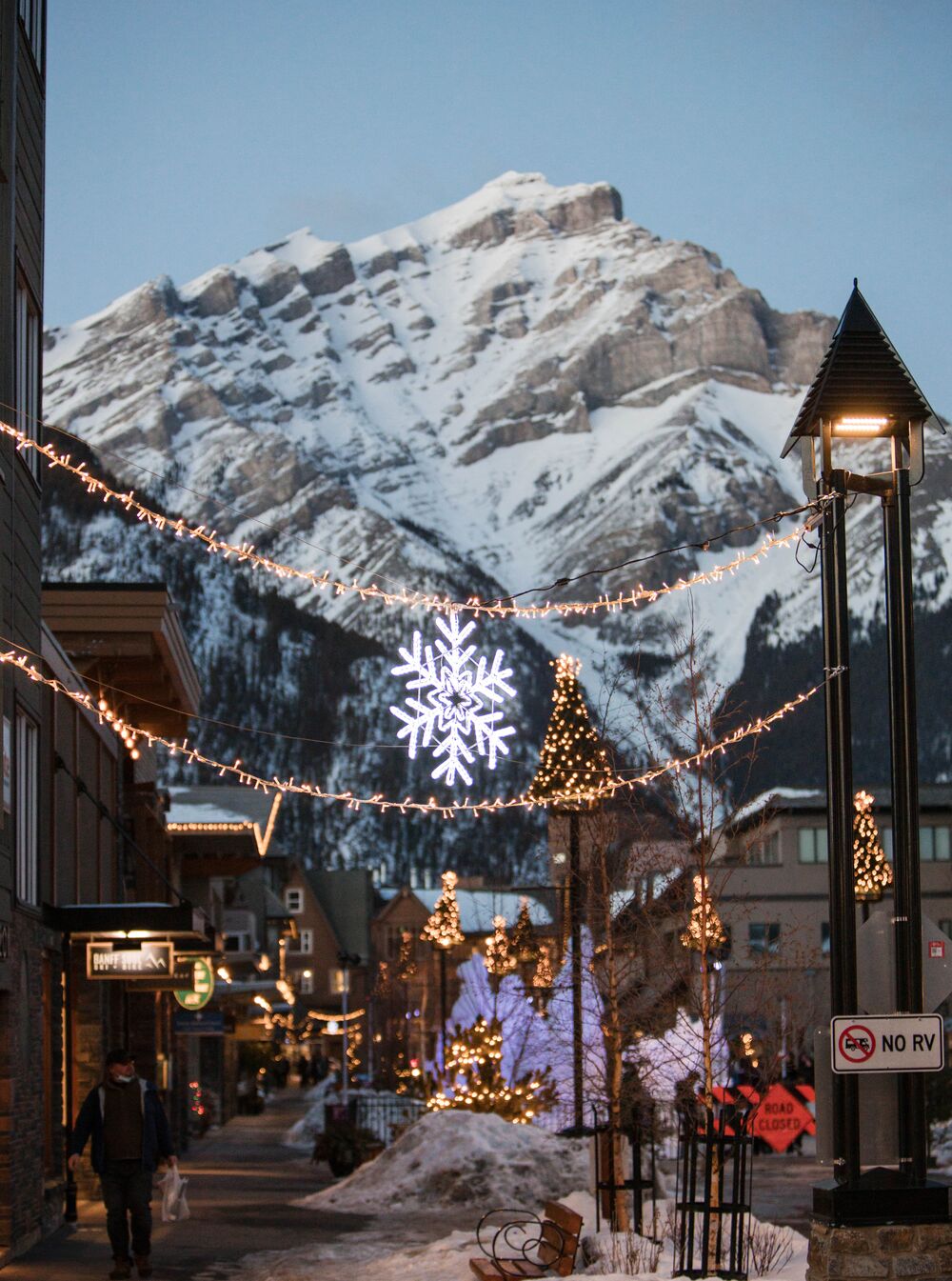 Christmas lights on Banff Ave with Cascade Mountain in the background.
