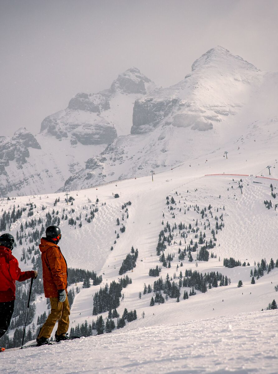 Skiers look off in the distance at the ski lifts at Banff Sunshine Village Ski Resort in Banff National Park.