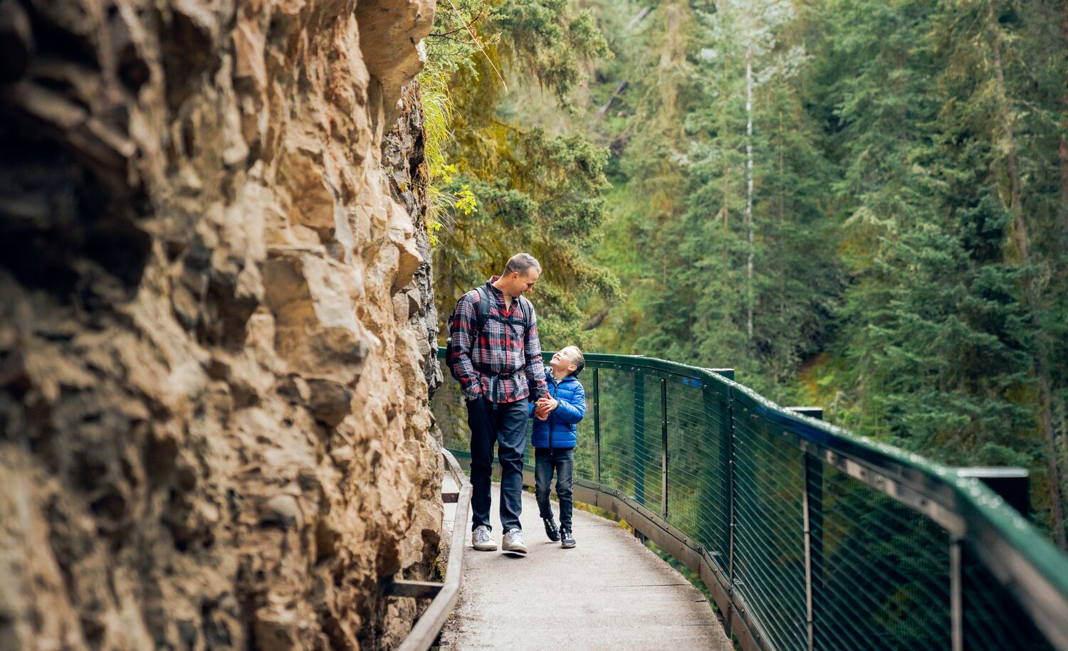 A father and son hiking the Johnston Canyon trail in Banff National Park