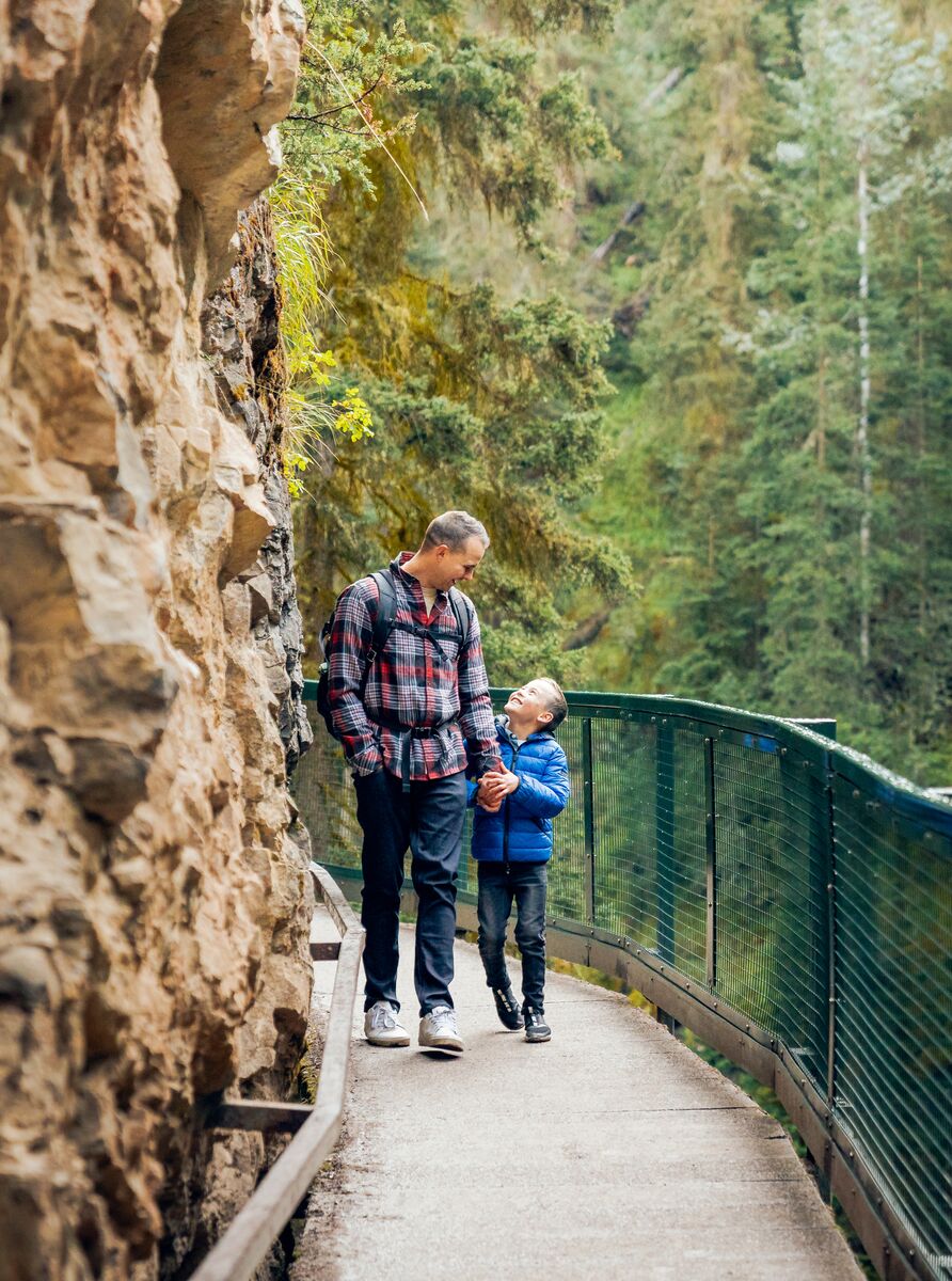 A father and son hiking the Johnston Canyon trail in Banff National Park