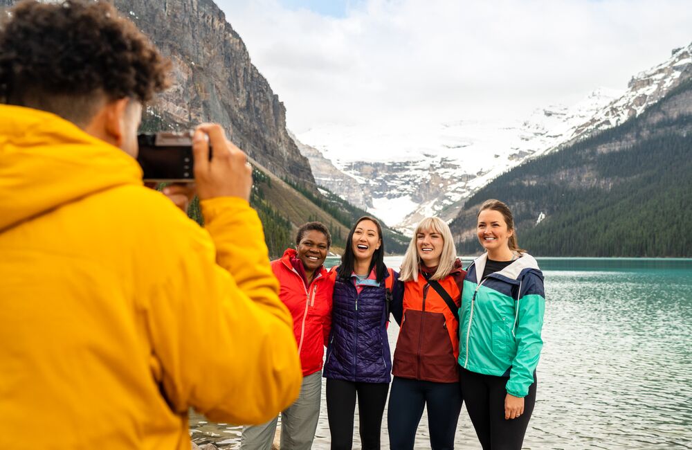 Friends visit Lake Louise together on a cool Fall day in Banff National Park