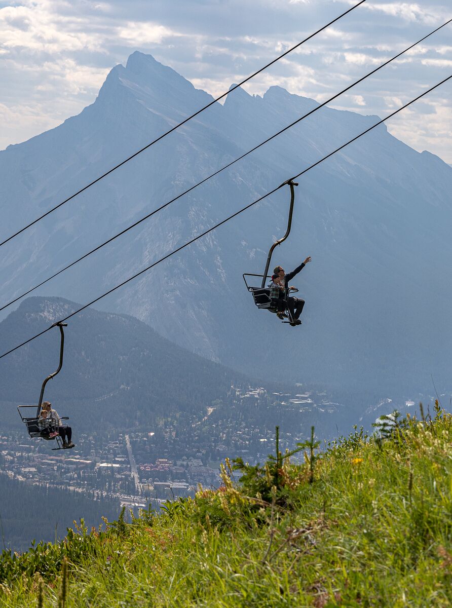 People enjoying the summer sightseeing gondola at Mt Norquay on a beautiful day in Banff National Park.