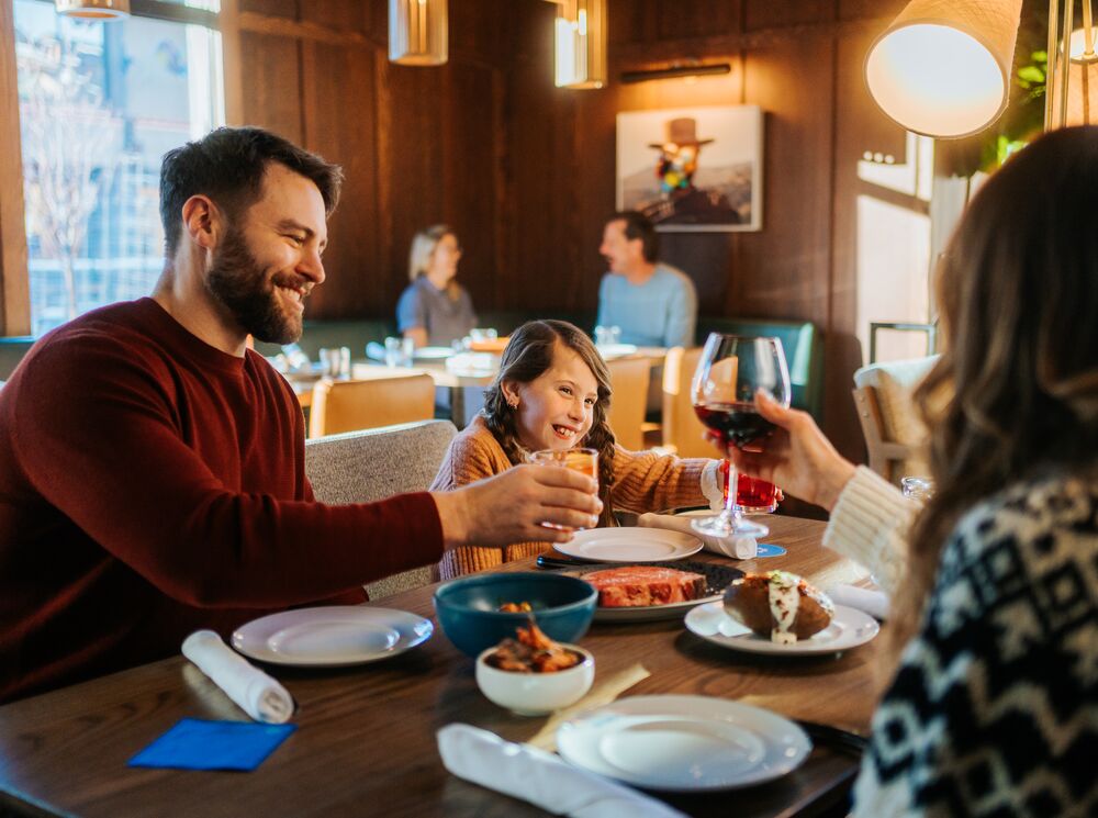 A family eats dinner inside Bluebird in Banff.